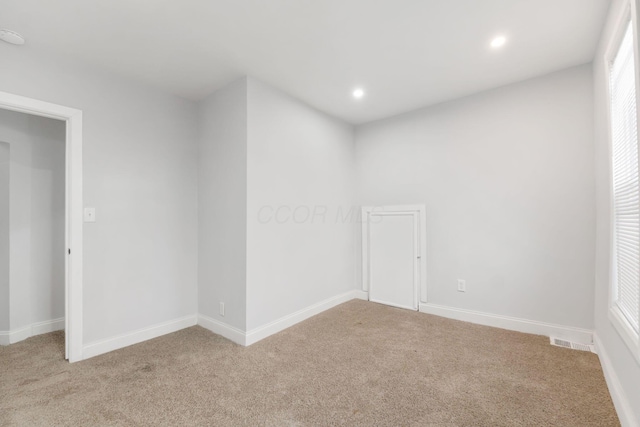 unfurnished room with light carpet