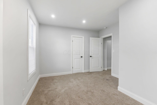 empty room featuring light colored carpet