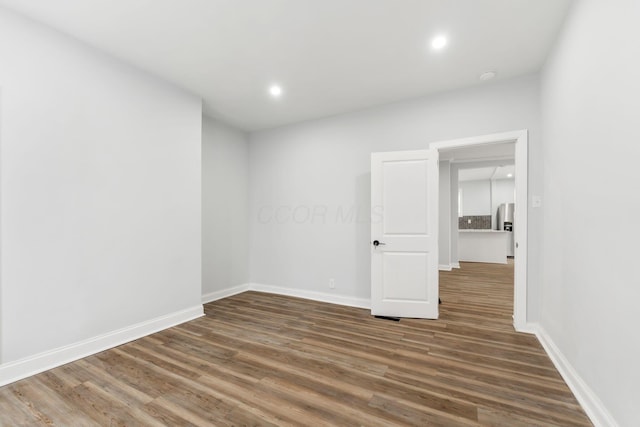 empty room with dark wood-type flooring