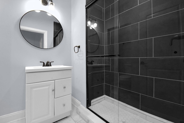 bathroom featuring vanity and an enclosed shower