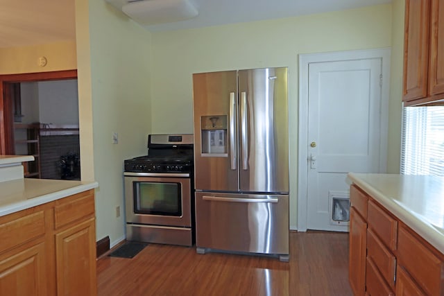 kitchen with dark wood-type flooring and stainless steel appliances