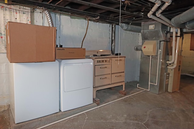 basement featuring washer and dryer and heating unit