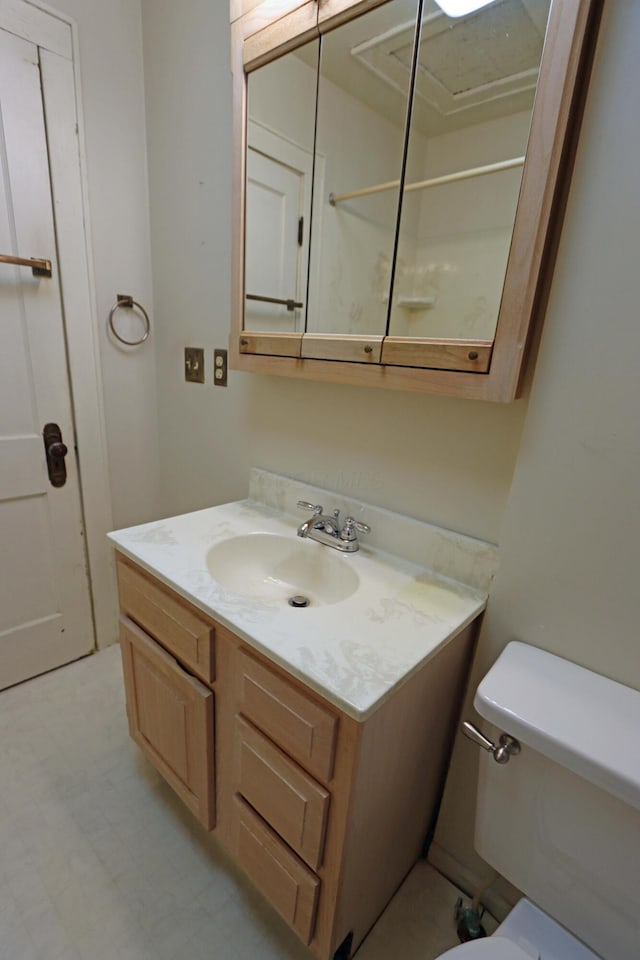 bathroom featuring vanity and toilet