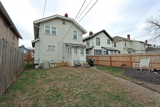 back of property featuring a lawn