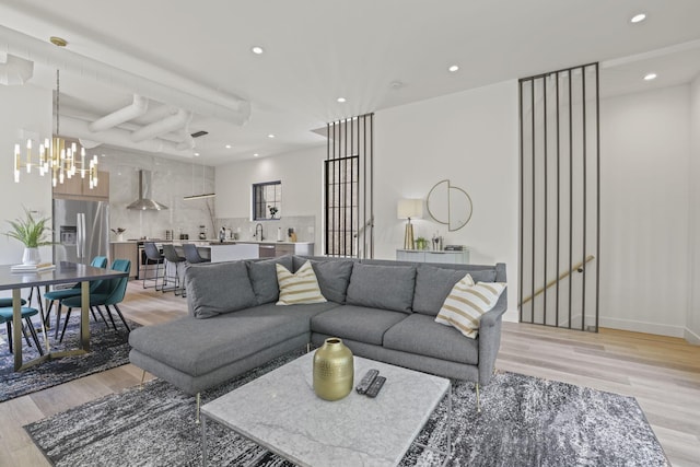 living room featuring a notable chandelier and light hardwood / wood-style floors