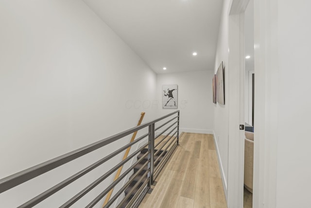 hallway with light hardwood / wood-style flooring