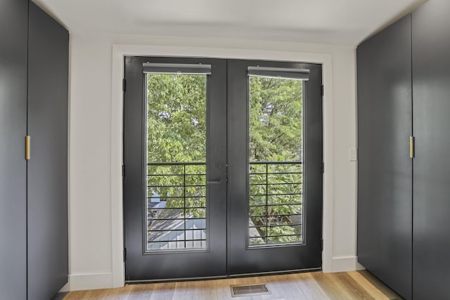 doorway to outside featuring french doors and light hardwood / wood-style floors