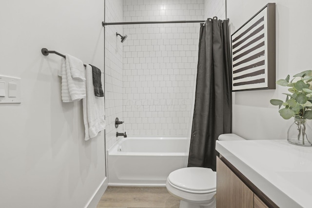 full bathroom featuring hardwood / wood-style floors, vanity, toilet, and shower / bathtub combination with curtain