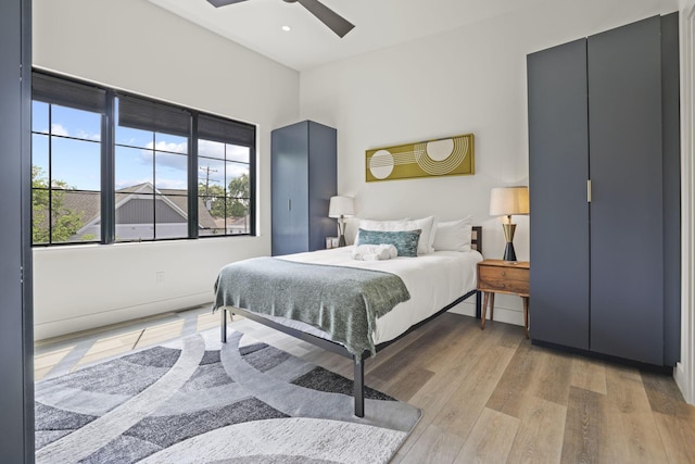 bedroom with ceiling fan and light wood-type flooring