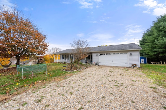 ranch-style home with a front yard, a porch, and a garage