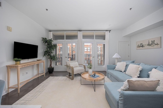 living room with dark hardwood / wood-style flooring and french doors