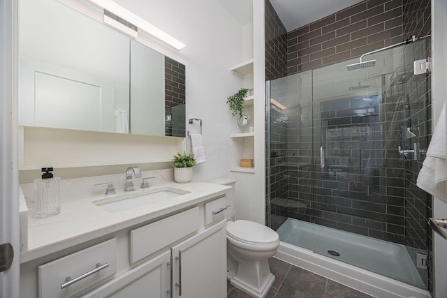 bathroom with tile patterned flooring, vanity, a shower with shower door, and toilet