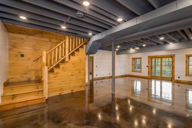 basement featuring wood walls