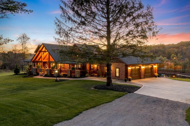 view of front facade with a garage and a yard