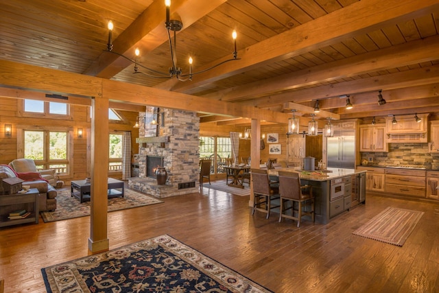 kitchen with decorative light fixtures, a center island, dark hardwood / wood-style floors, and a breakfast bar area