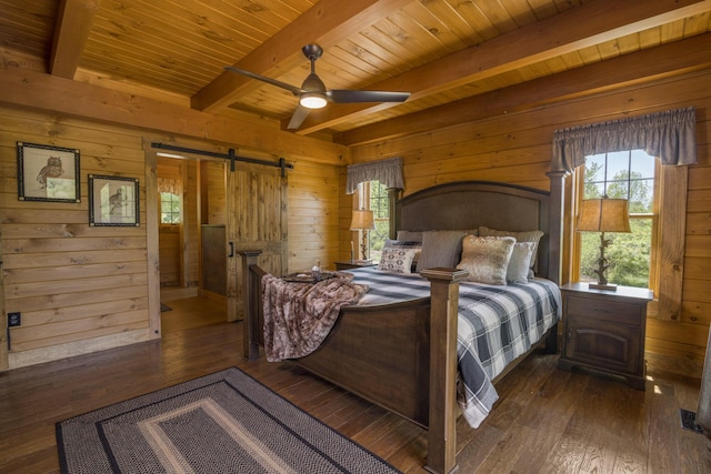 bedroom with wood ceiling, wooden walls, dark wood-type flooring, a barn door, and beamed ceiling