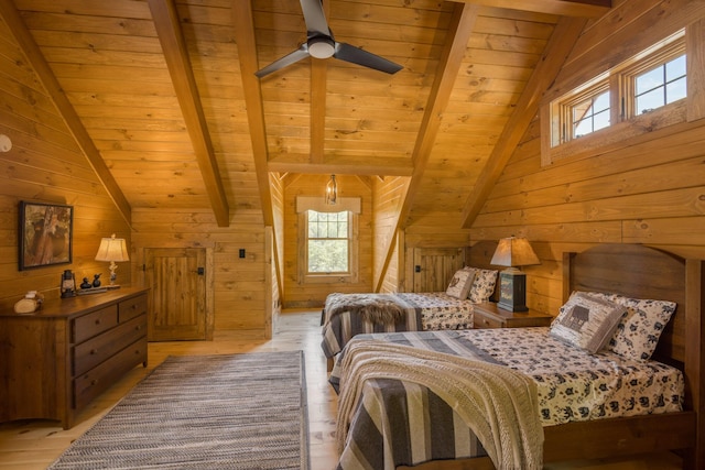 bedroom featuring wooden walls, light hardwood / wood-style flooring, ceiling fan, and wooden ceiling