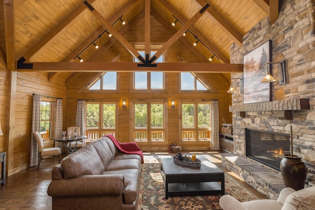 living room featuring hardwood / wood-style flooring, a stone fireplace, wood ceiling, and high vaulted ceiling