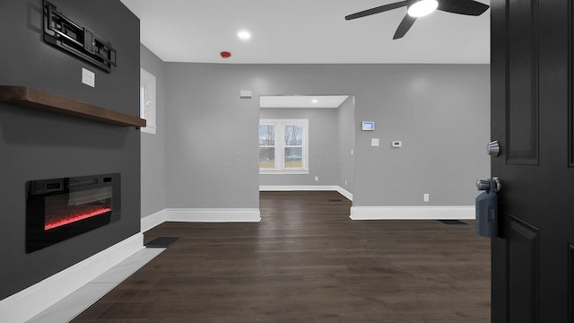 living room featuring dark hardwood / wood-style floors and ceiling fan