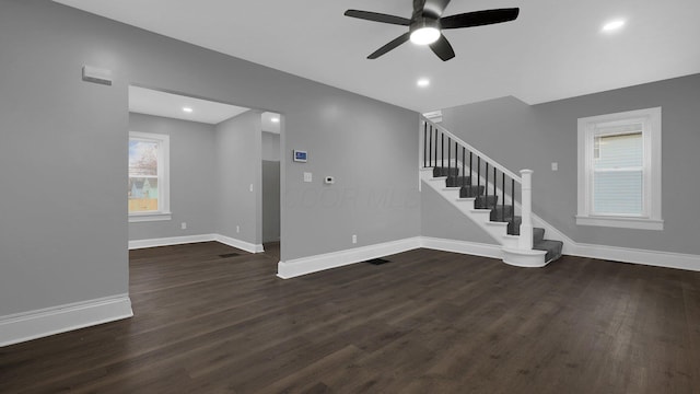 unfurnished living room with ceiling fan and dark hardwood / wood-style floors