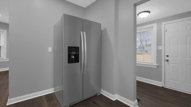 interior space featuring dark hardwood / wood-style floors and stainless steel refrigerator with ice dispenser