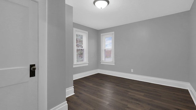 spare room featuring dark hardwood / wood-style flooring