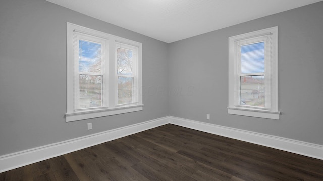 spare room featuring hardwood / wood-style floors and a wealth of natural light