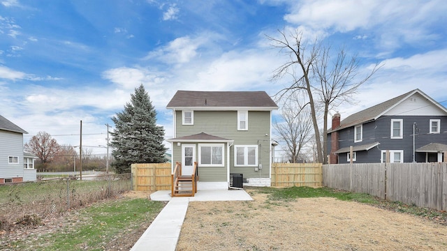 rear view of house with central AC unit