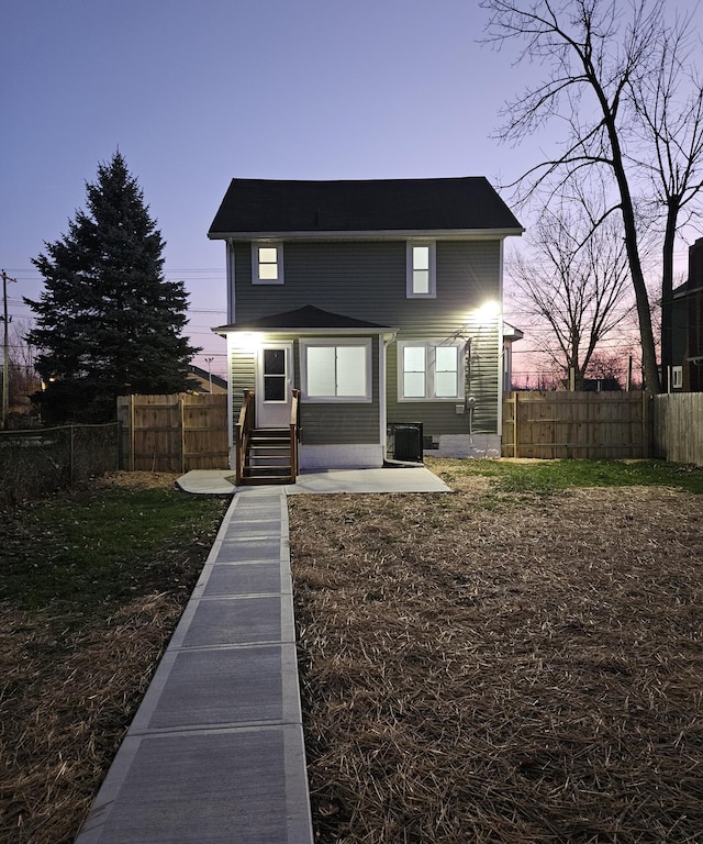 back house at dusk with cooling unit