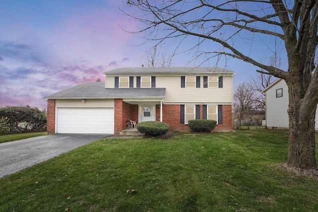 view of front of property with a yard and a garage