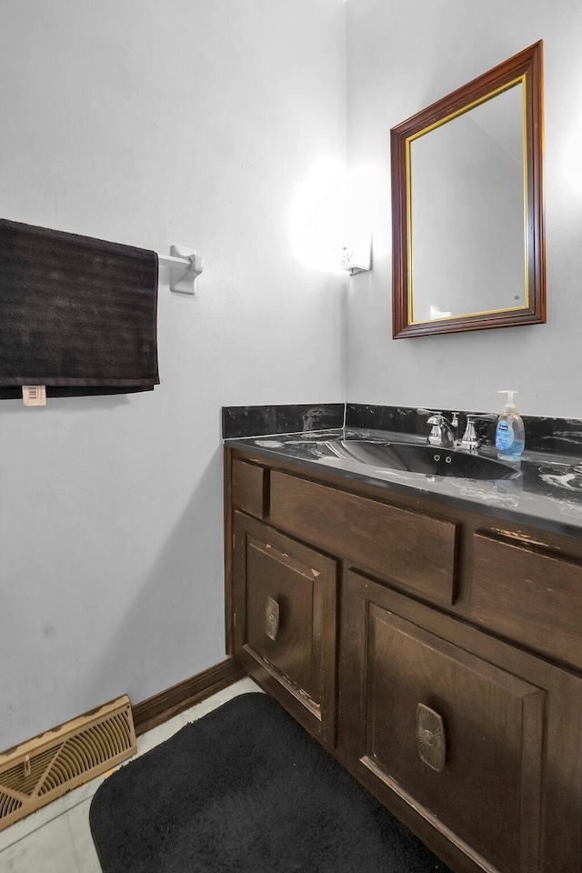 bathroom featuring tile patterned flooring and vanity