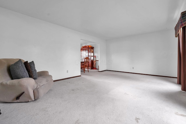 unfurnished living room with light colored carpet