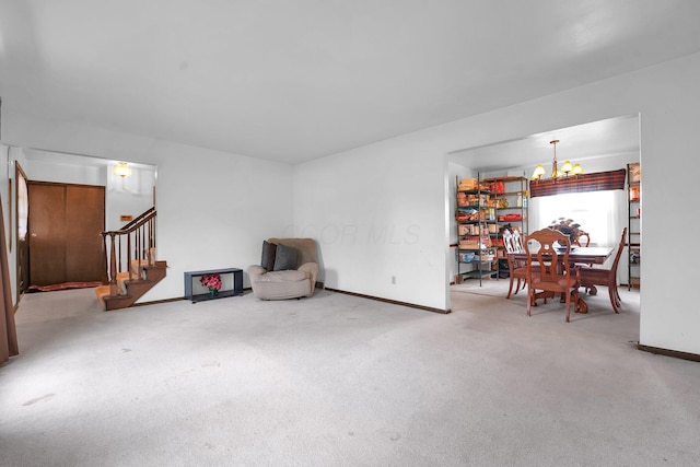 sitting room with carpet flooring and an inviting chandelier