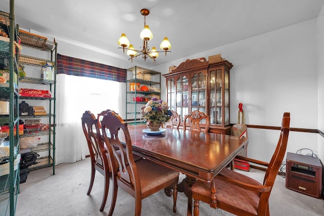 dining room featuring light carpet and an inviting chandelier