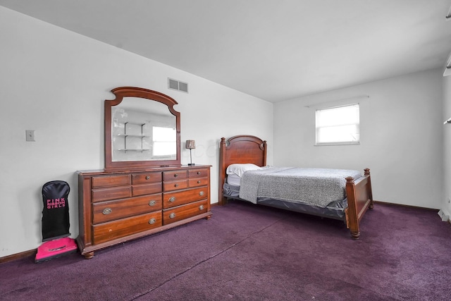 bedroom with dark colored carpet