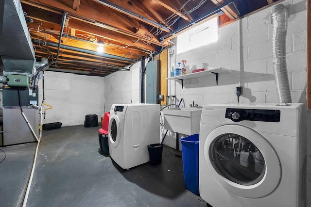 washroom with electric panel, washer and clothes dryer, heating unit, and sink