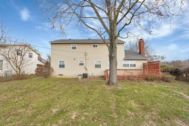 rear view of house featuring a lawn, a wooden deck, and central AC