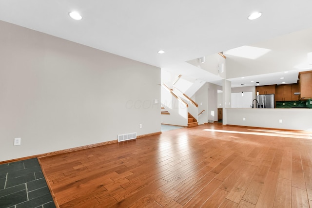 unfurnished living room with light hardwood / wood-style flooring