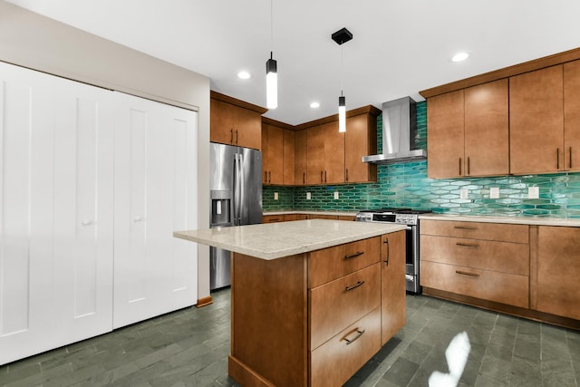 kitchen with pendant lighting, backsplash, wall chimney exhaust hood, appliances with stainless steel finishes, and a kitchen island