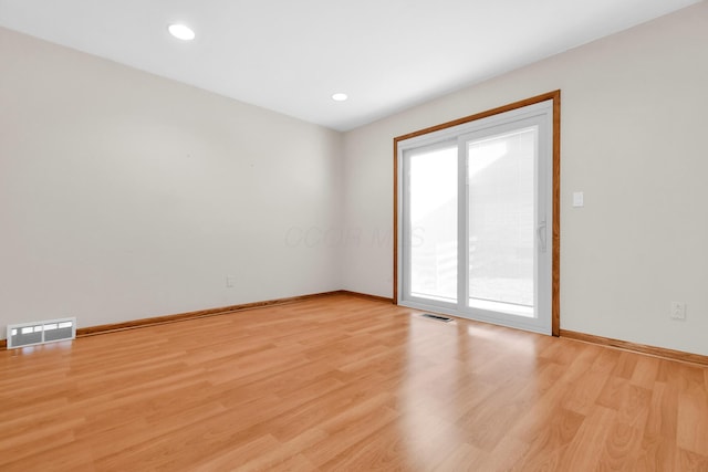 empty room with light hardwood / wood-style floors