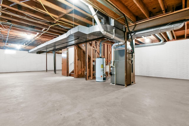 basement featuring heating unit and water heater