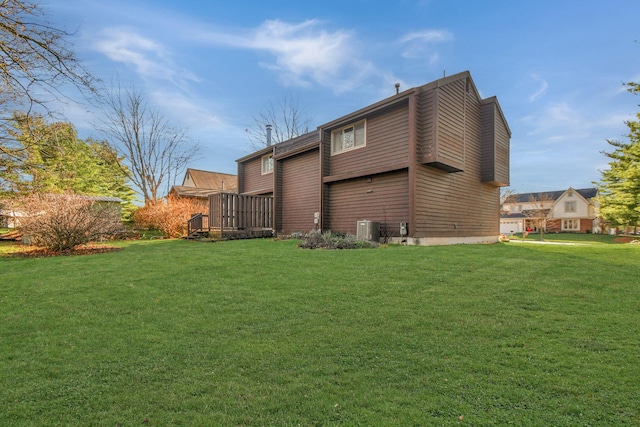 back of house with a yard and central AC unit