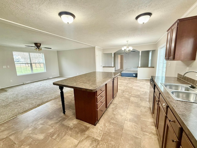 kitchen with stainless steel dishwasher, a textured ceiling, light colored carpet, sink, and a kitchen island