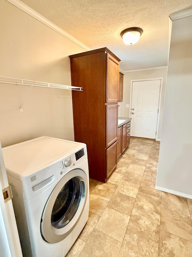 laundry room with cabinets, washer / dryer, a textured ceiling, and ornamental molding