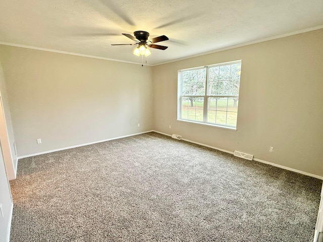 carpeted empty room with ceiling fan, a textured ceiling, and ornamental molding