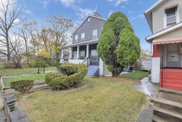 back of house featuring a lawn and central AC unit