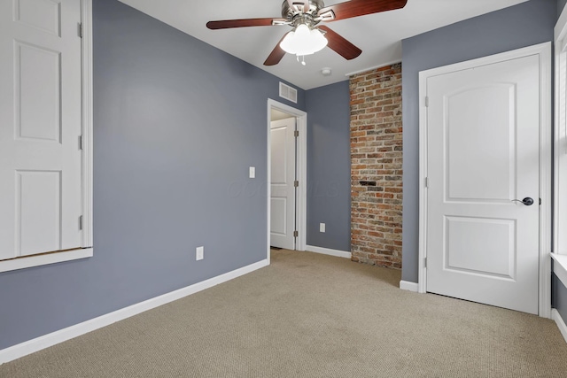 unfurnished bedroom featuring light carpet and ceiling fan