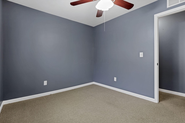 spare room featuring ceiling fan and carpet