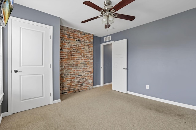 unfurnished bedroom featuring carpet and ceiling fan