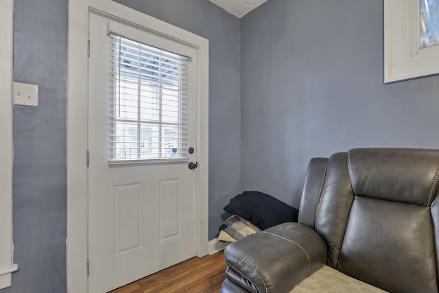 foyer entrance with wood-type flooring and a textured ceiling